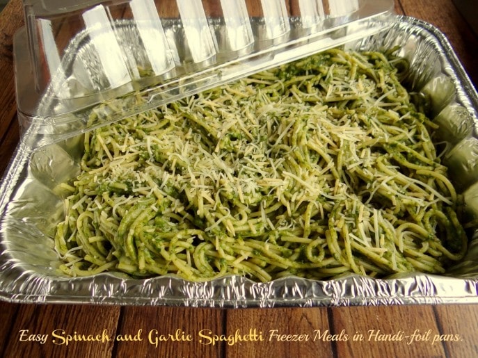 Making Spinach and Garlic Spaghetti Freezer Meals in Handi-foil pans.