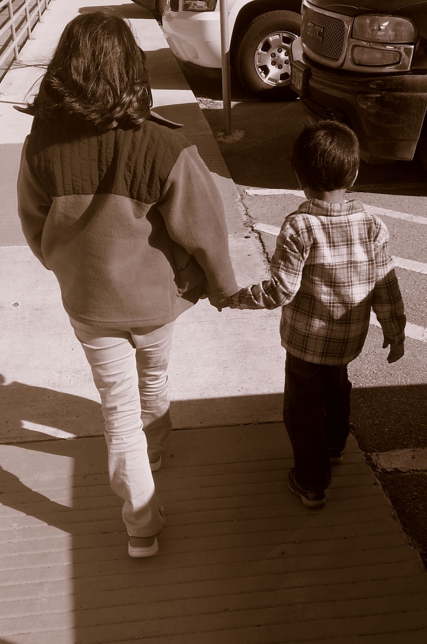 Big sister holding little brother's hand