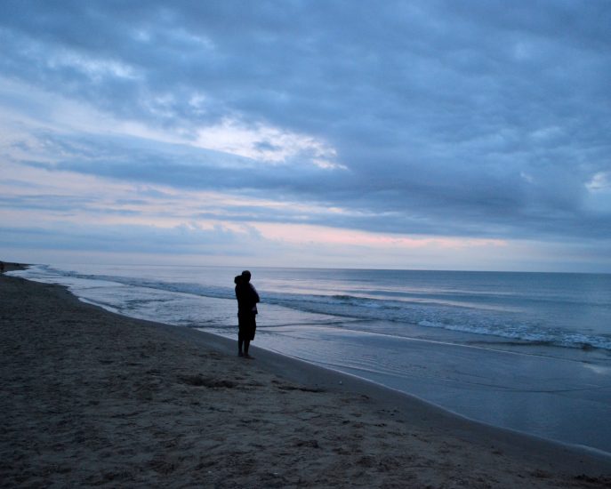 Father with baby watching the sunrise