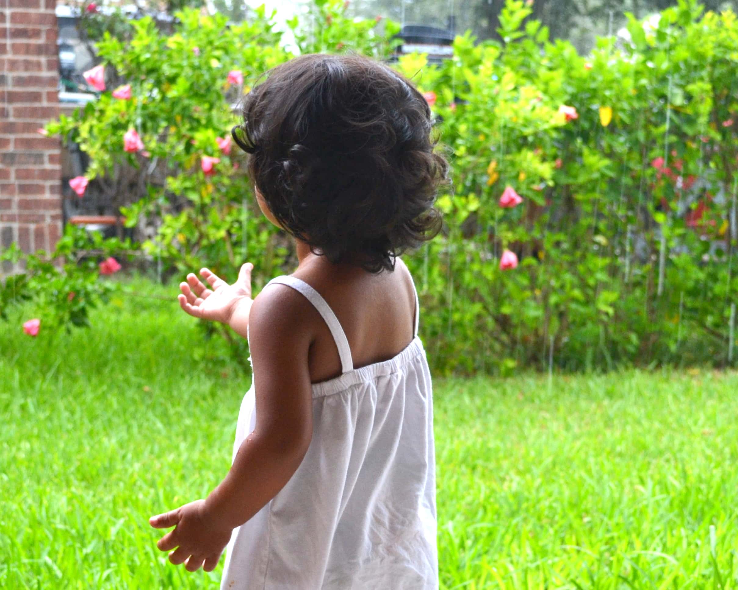 child catching raindrops