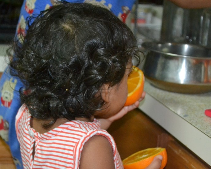 child eating an orange