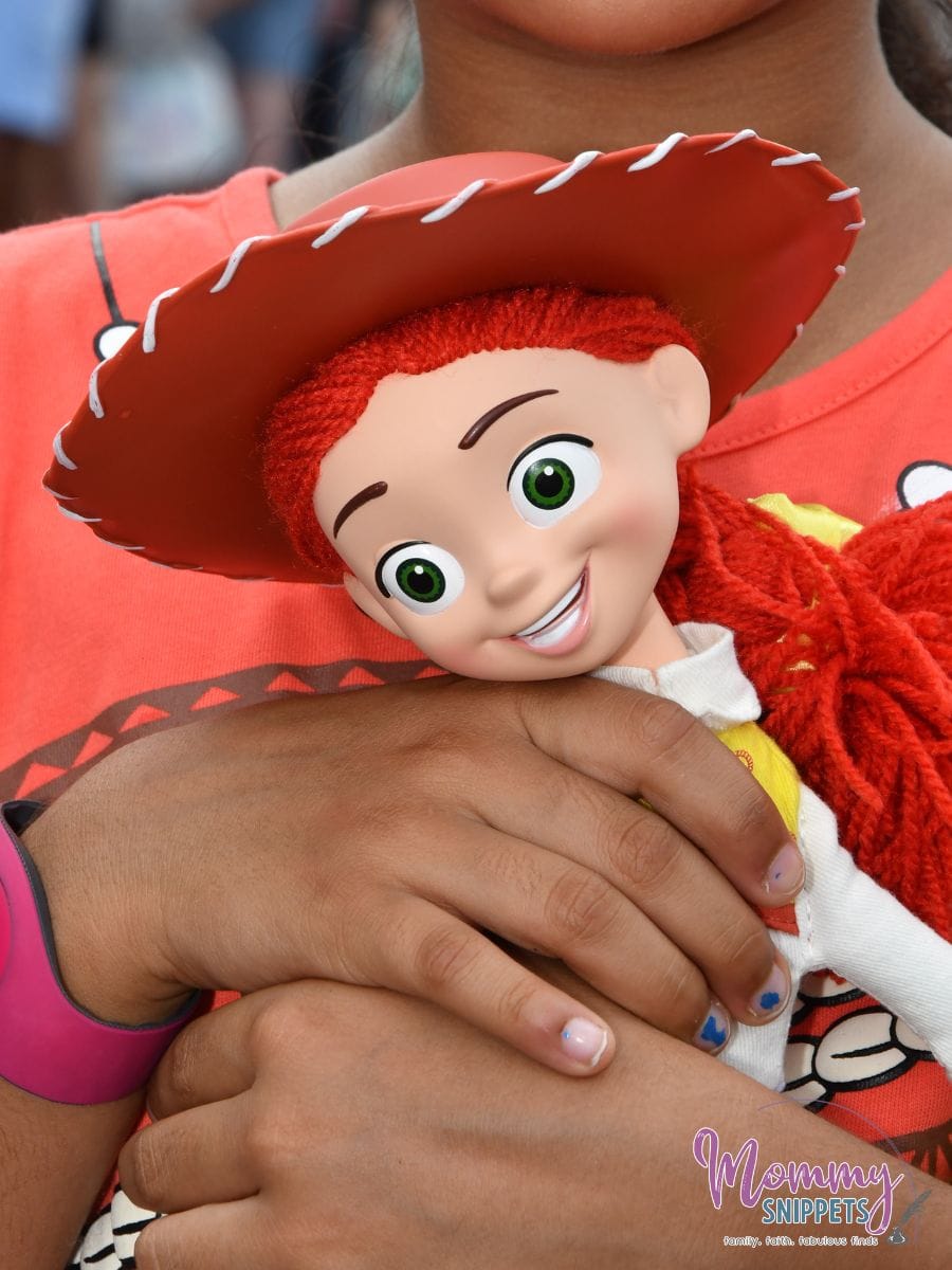 toy story jessie doll held by a little girl