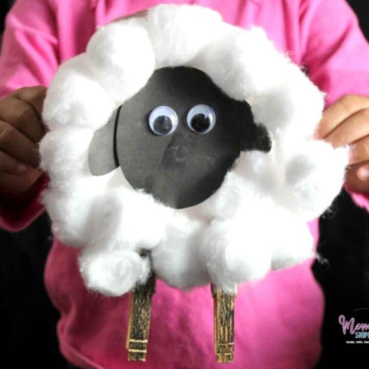 preschool child holding printable cotton ball sheep craft