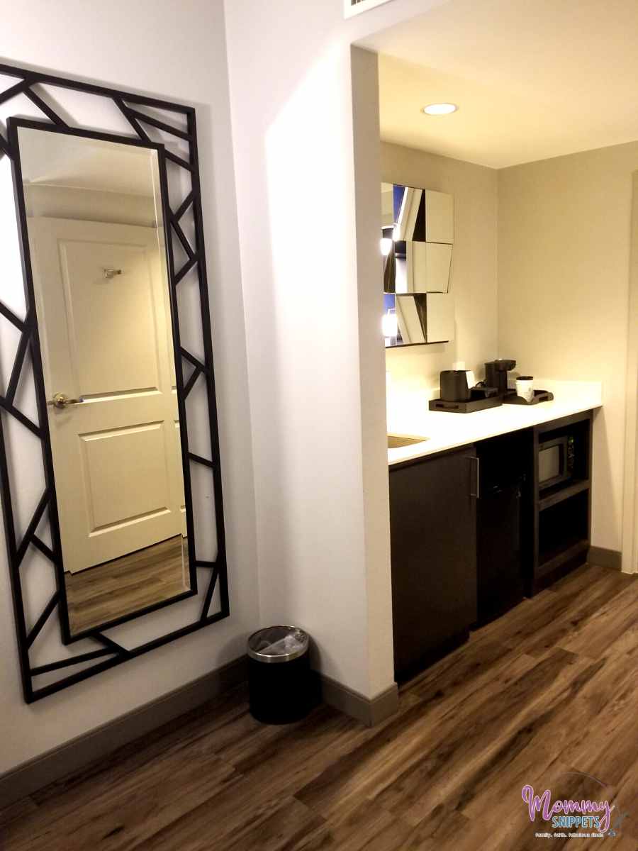 mini fridge, mirror and sink in a 2 room suite in the Embassy Suites by Hilton Houston Energy Corridor